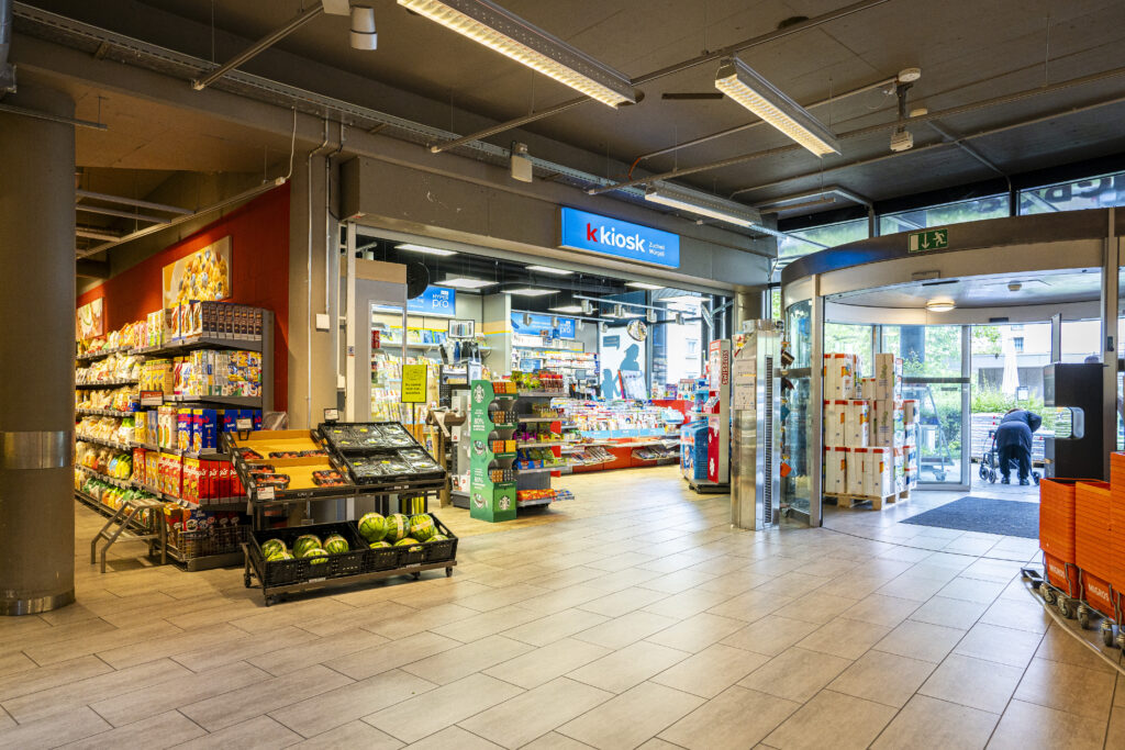 Shopping arcade in Zuchwil featuring the k-kiosk and a revolving door leading outside