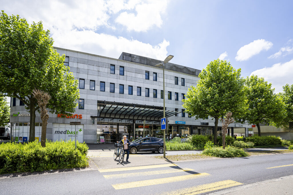 Street view of the commercial building in Zuchwil, housing Migros and the Medbase pharmacy