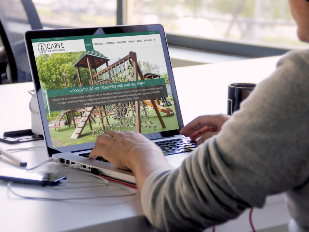 A person at a MacBook by the window, with the Carve homepage and the slogan about creativity and safety