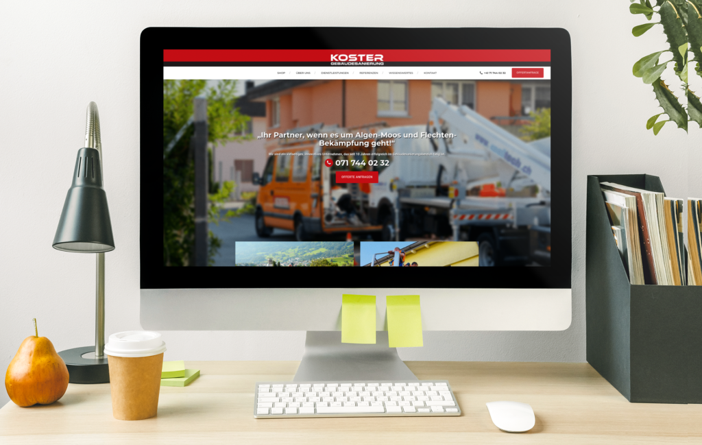 An iMac on a desk, with the homepage of Koster Gebäudesanierung and the orange company car